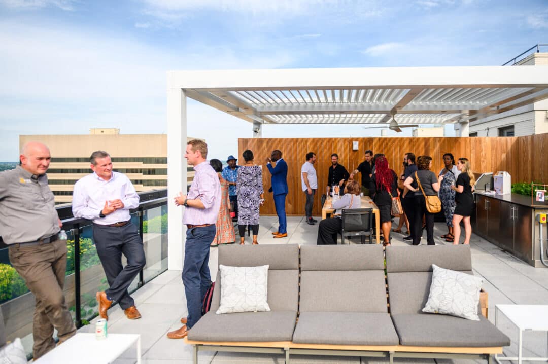 Guests mingling at the rooftop lounge and grilling area at 101 dupont place.